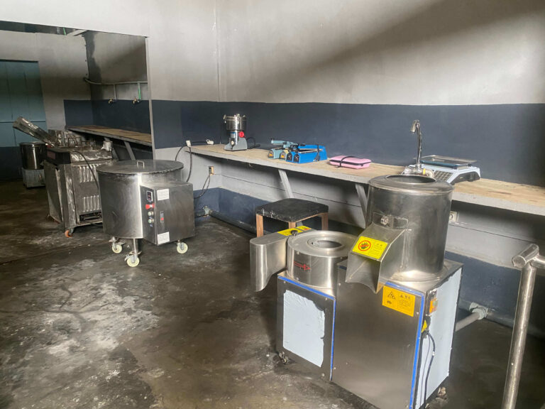A Mumita processing room with stainless machines on benches along the walls