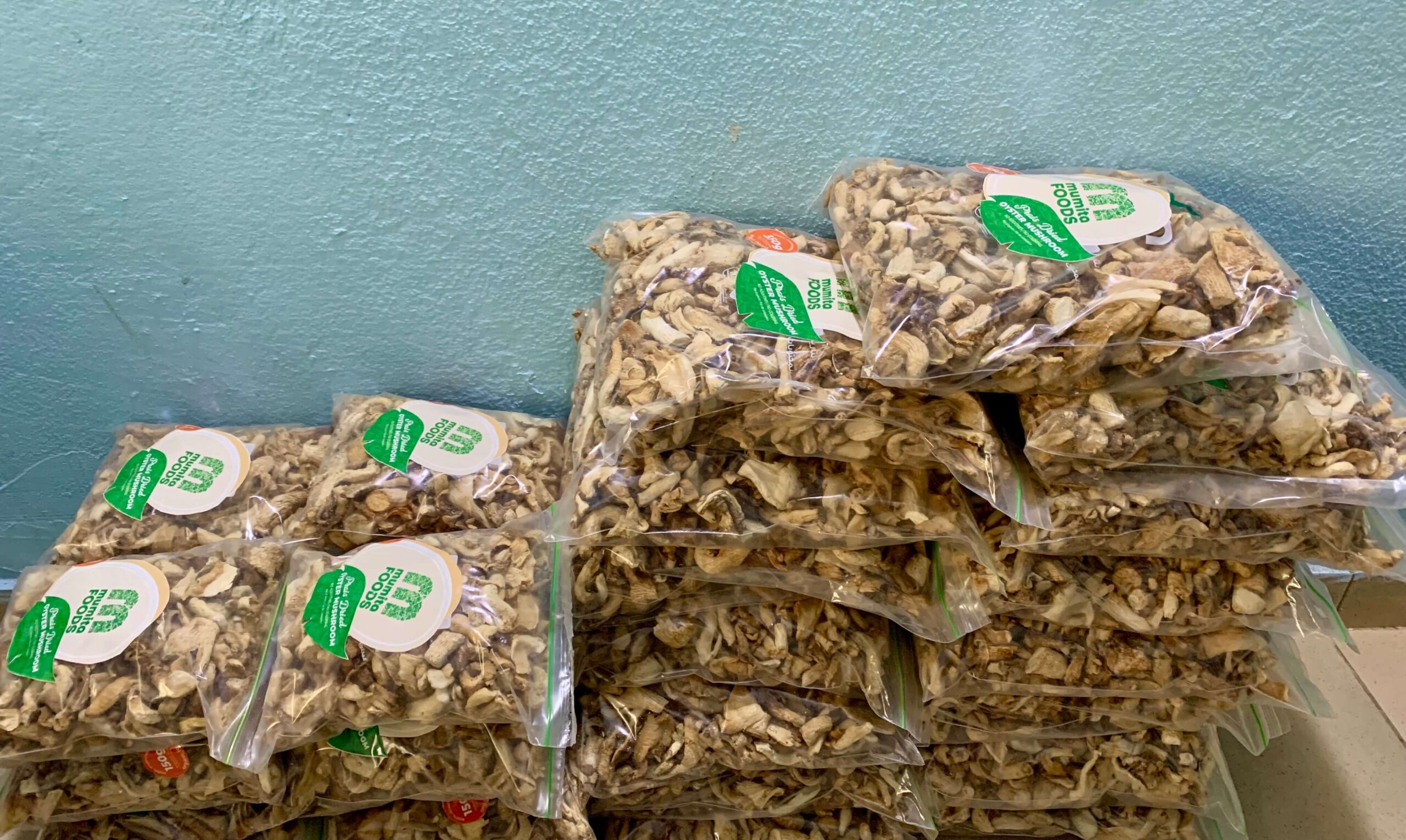 Bags of dried mushroom slices stacked on a table