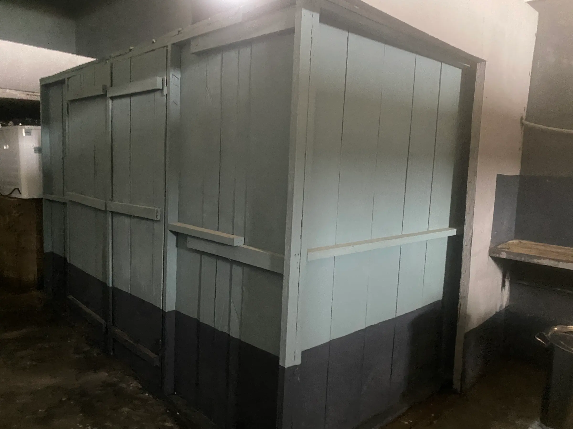 An insulated grey panel cold room inside the processing hall