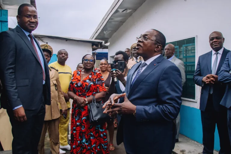 An official addresses guests outside the facility during the MINESUP visit