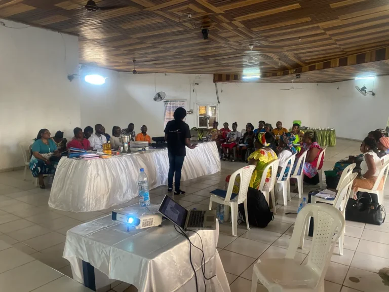 A wide training hall with participants seated