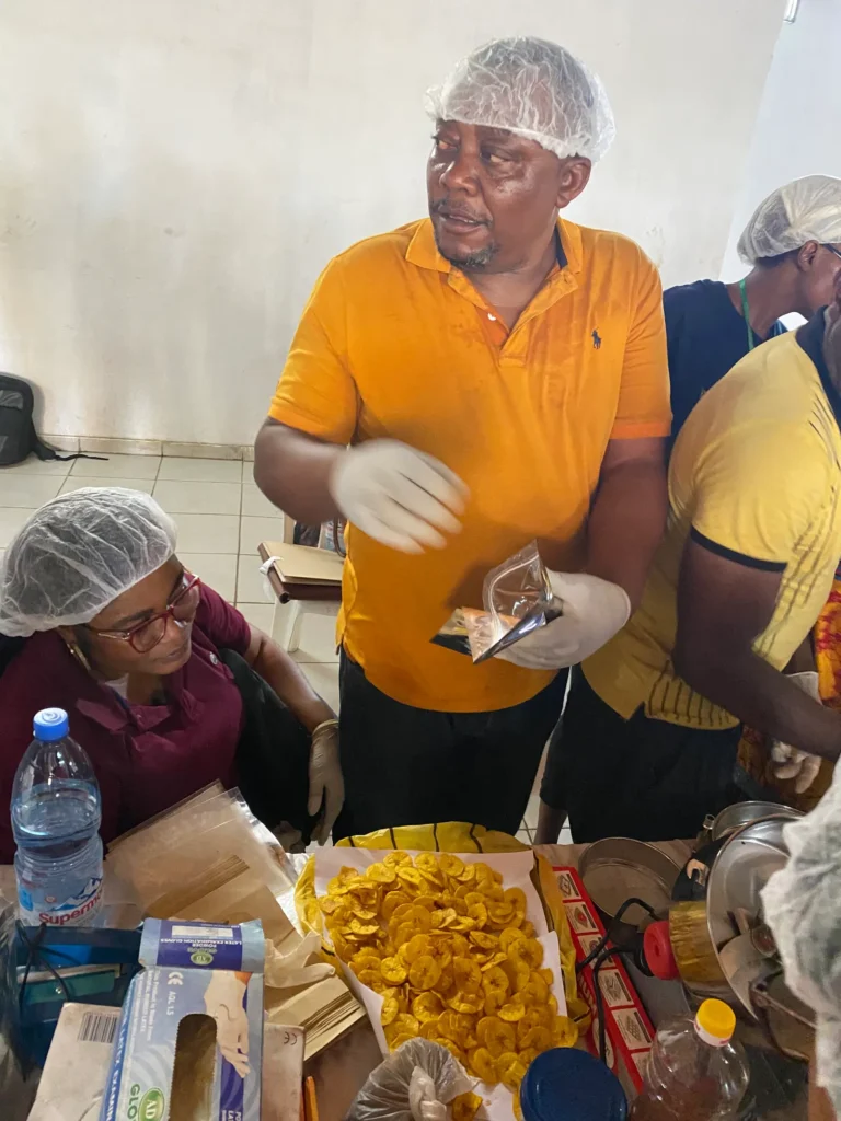A trainer packs plantain chips into pouches