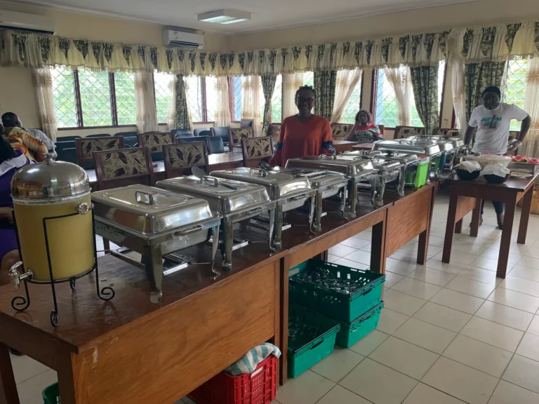 A long catering buffet of chafing dishes in a function hall