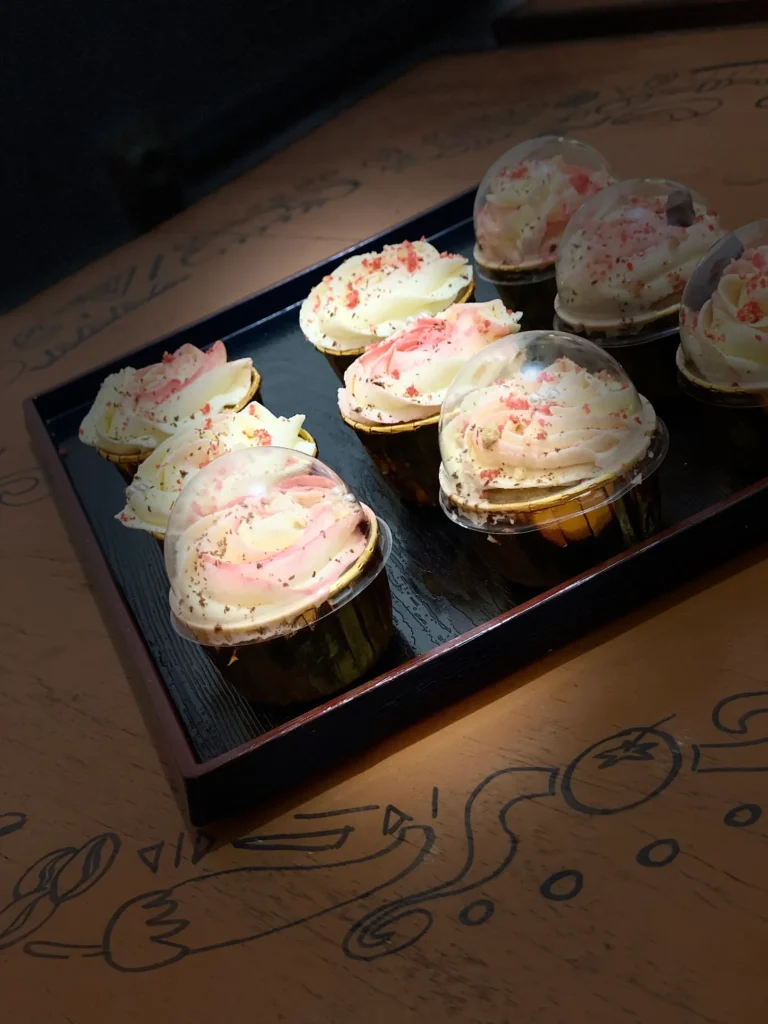 Cream cupcakes on a black tray