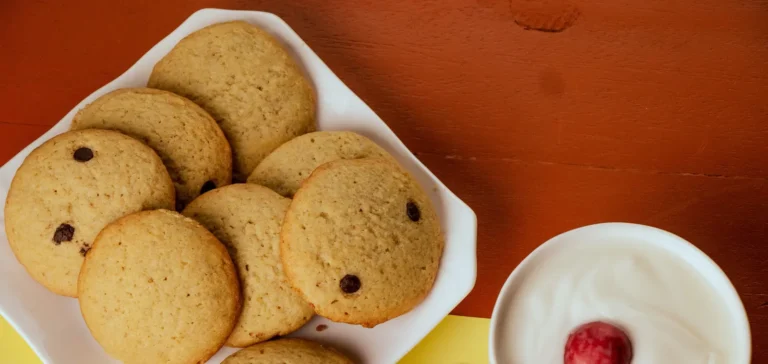 Cookies with a bowl of yoghurt and cherries