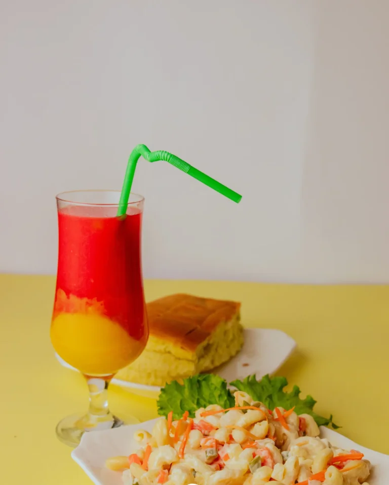 A layered fruit juice with cake and macaroni salad